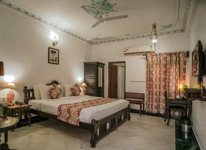 Comfortable guest room at The Lavitra Heritage Hotel, Udaipur, with traditional-inspired interiors and modern amenities.