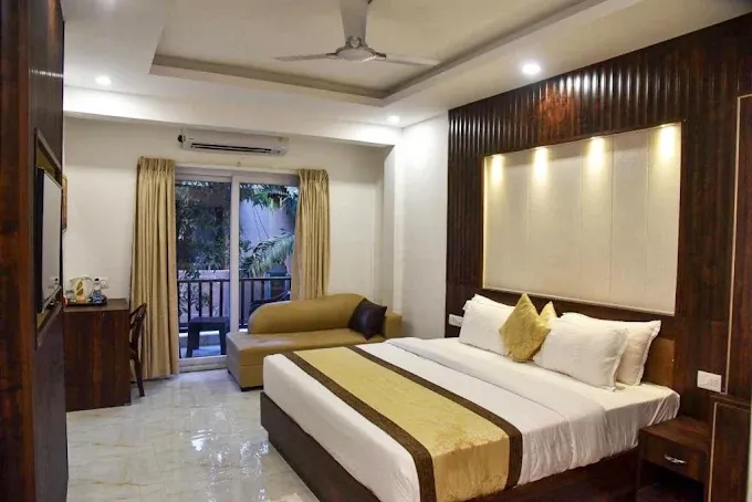 Guest room balcony at De Falcon Goa Beach Resort overlooking the garden or swimming pool area.