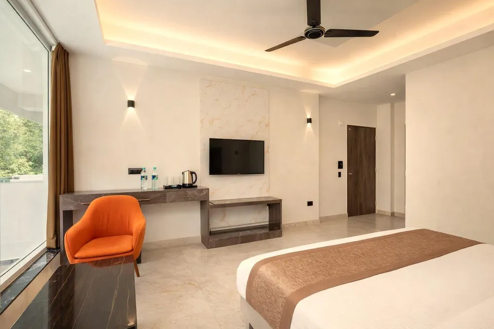 Comfortable hotel room at Hotel Creek Valley, Mussoorie, featuring elegant interiors, cosy bedding, modern amenities and scenic mountain views.