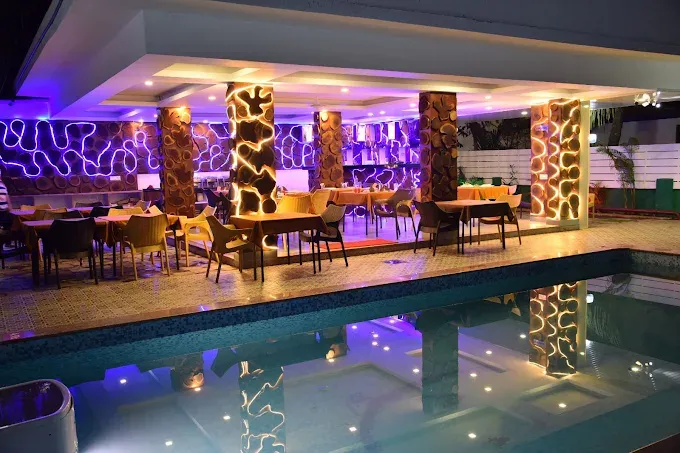 Outdoor swimming pool at De Falcon Goa Beach Resort with a relaxing setting for guests to unwind during their Goa holiday.