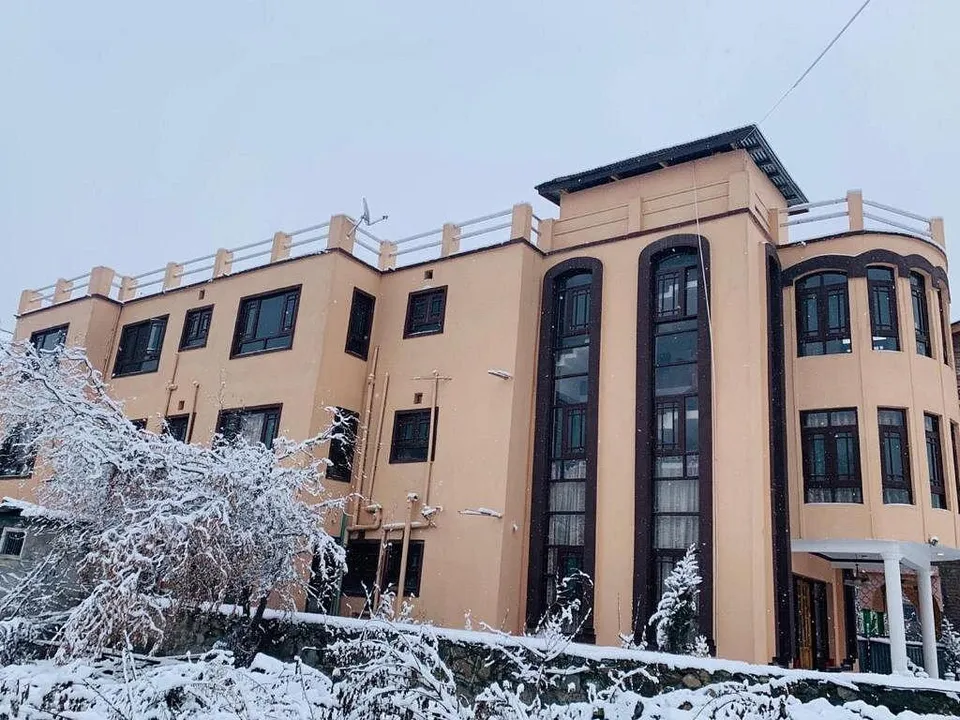 Exterior view of The Shelter Heritage in Srinagar, showcasing its welcoming entrance and boutique hotel setting.